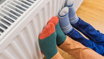 Woman and child wearing colorful pair of woolly socks warming co